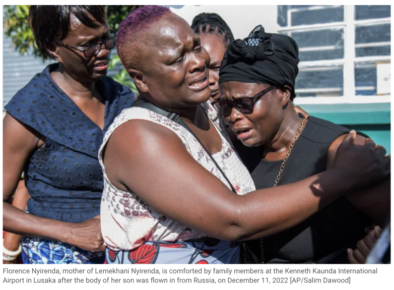 Florence Nyirenda, mother of Lemekhani Nyirenda, is comforted by family members at the Kenneth Kaunda International Airport in Lusaka after the body of her son was flown in from Russia, on December 11, 2022. Photo by AP photographer, Salim Dawood.